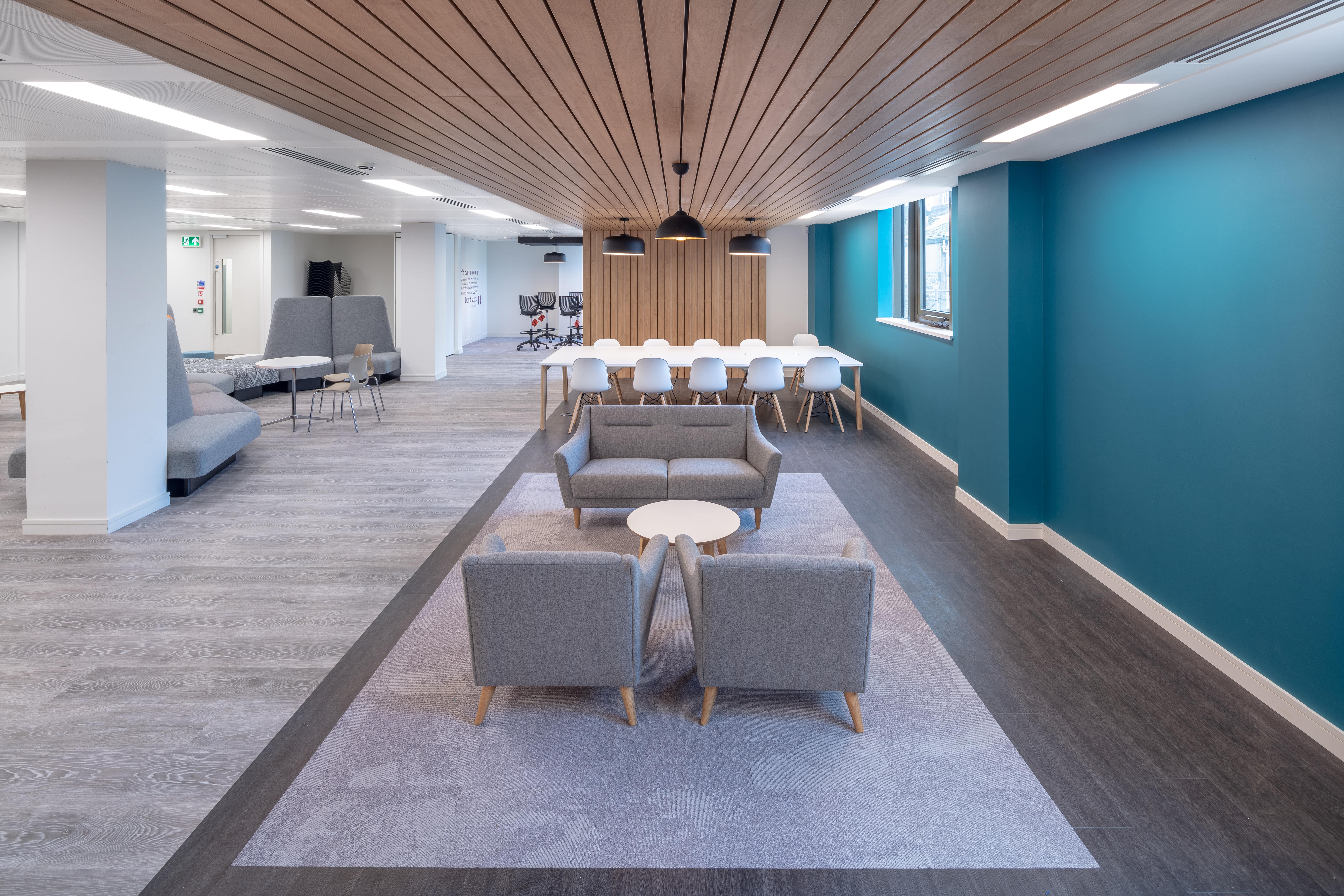 Open-plan business lounge with acoustic wood panel features